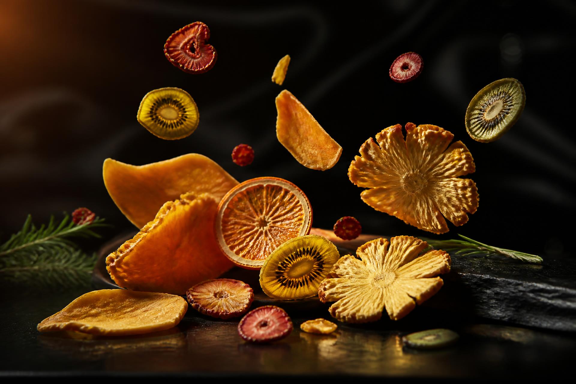 Premium dried fruits arranged on a dark surface with dramatic lighting